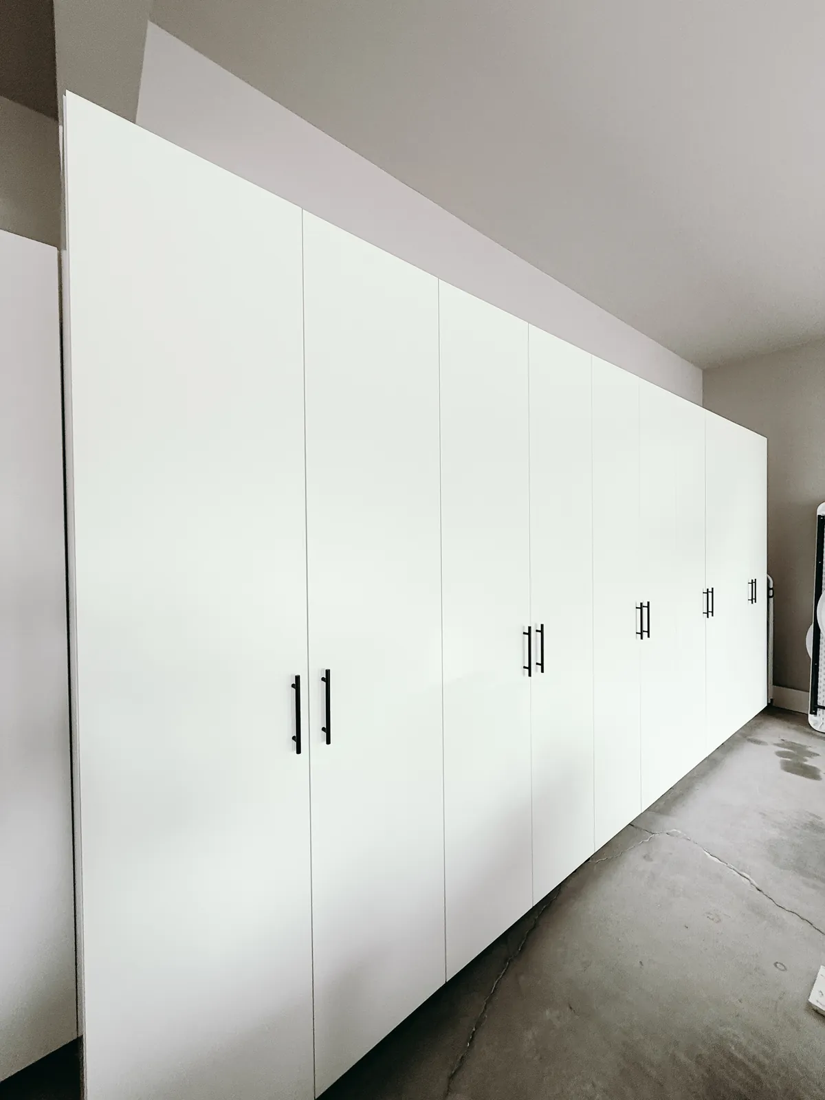 Full-Wall White Garage Cabinet System — finished view 3